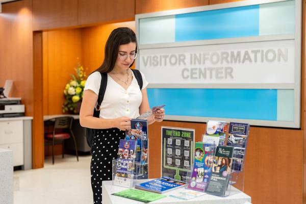 young woman looking at brochures