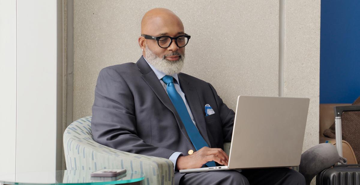 Man on laptop in terminal.